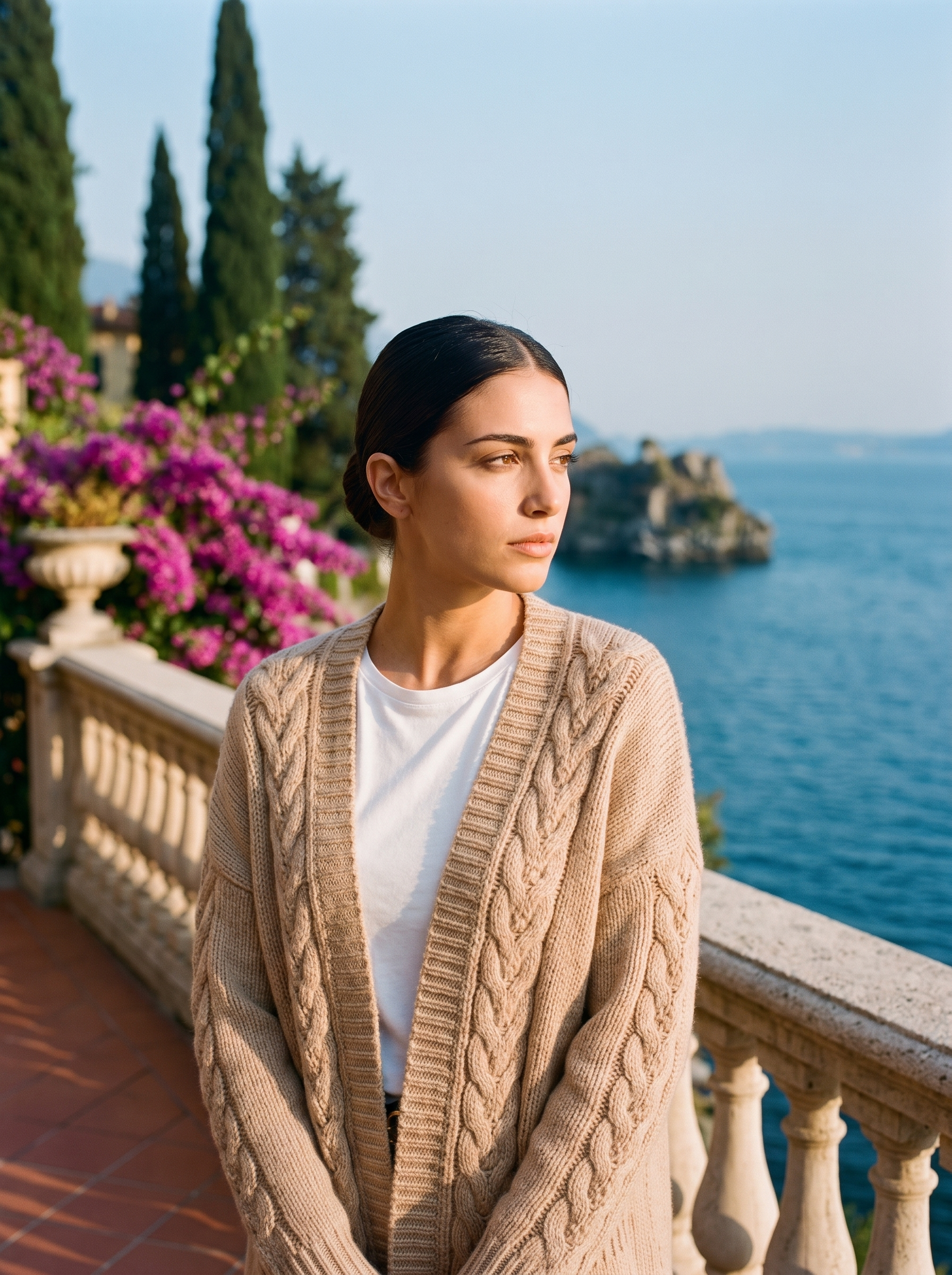 Woman wearing a khaki open-front cardigan on a terrace overlooking Lake Como, old money style — Aveloire