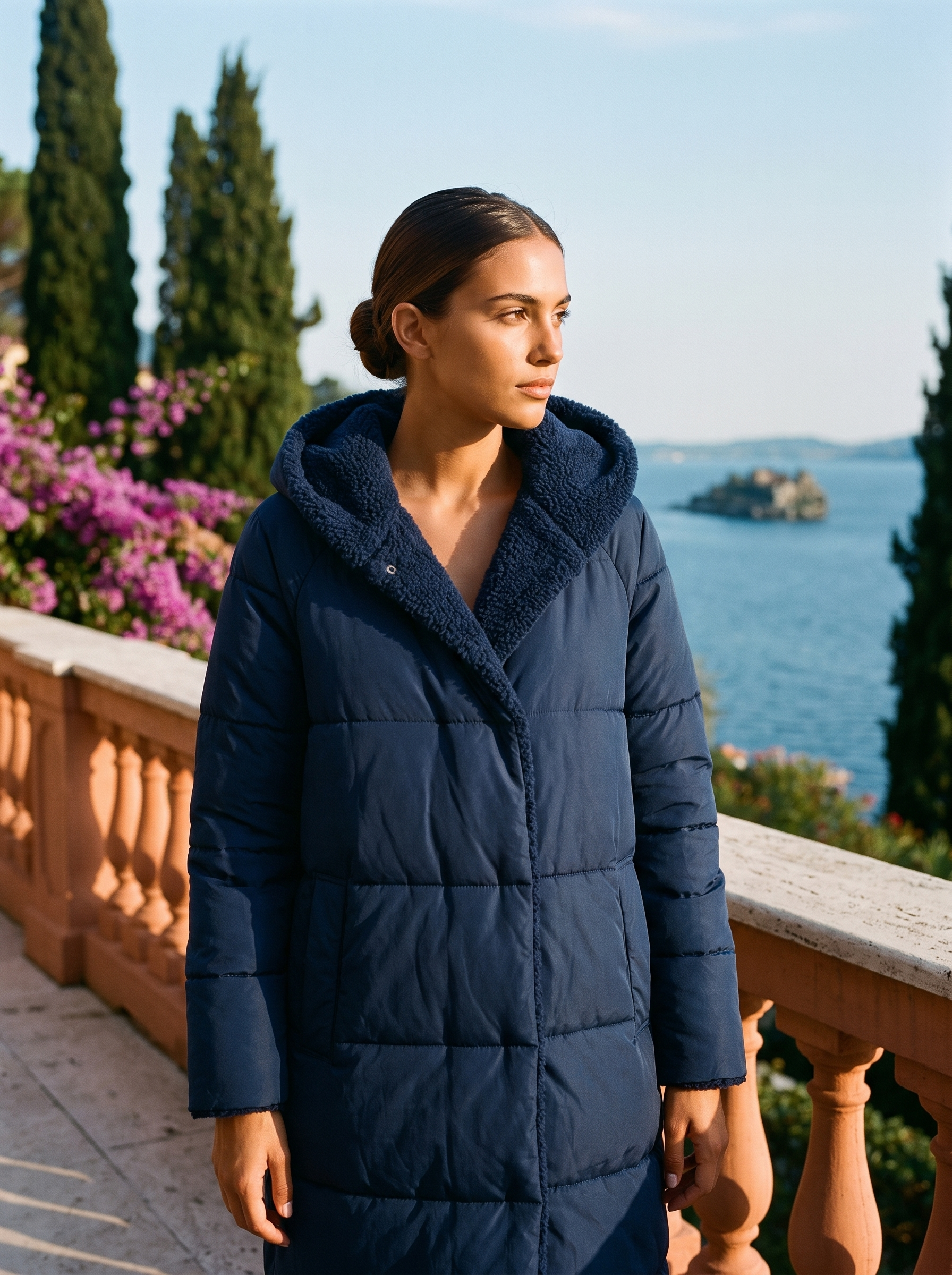 Woman wearing navy puffer coat on a Lake Como terrace — Aveloire