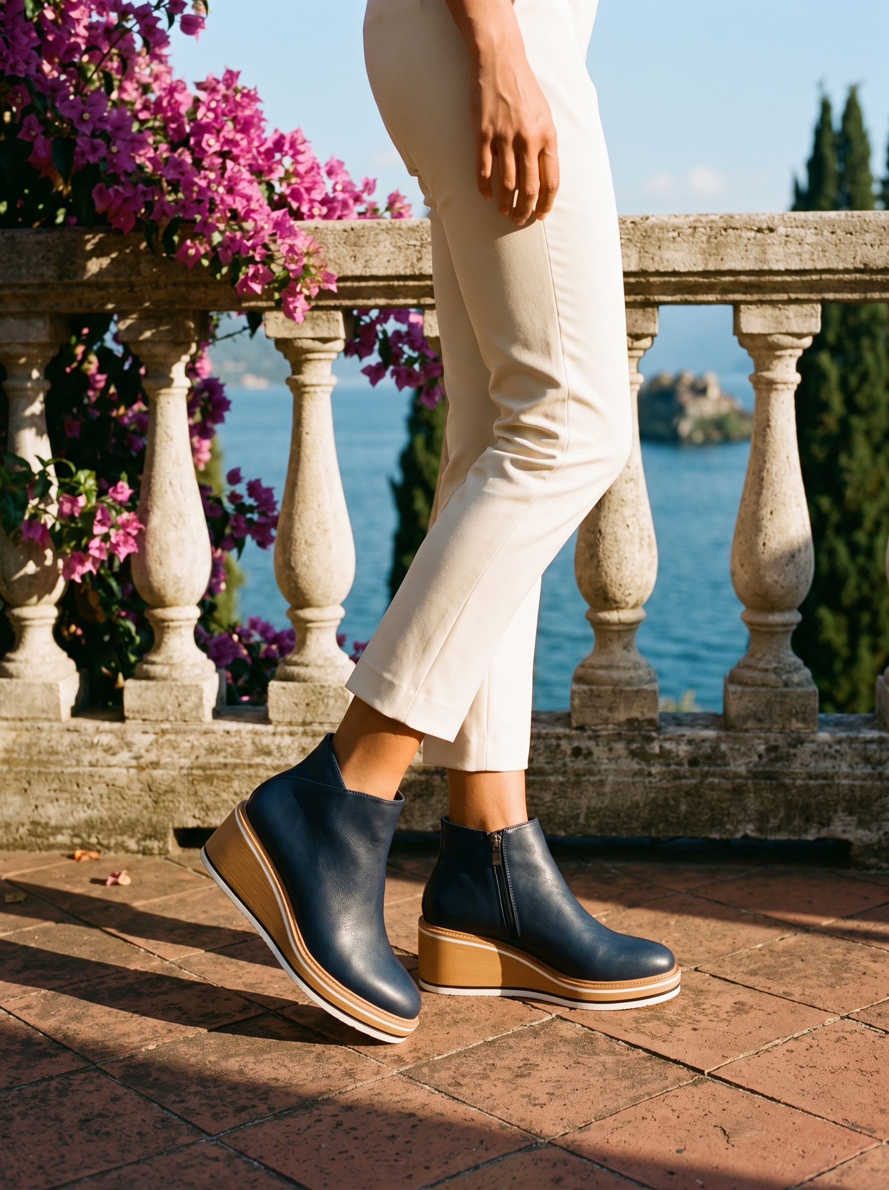 Woman wearing navy contrast wedge ankle boots on a terrace overlooking Lake Como, old money style — Aveloire
