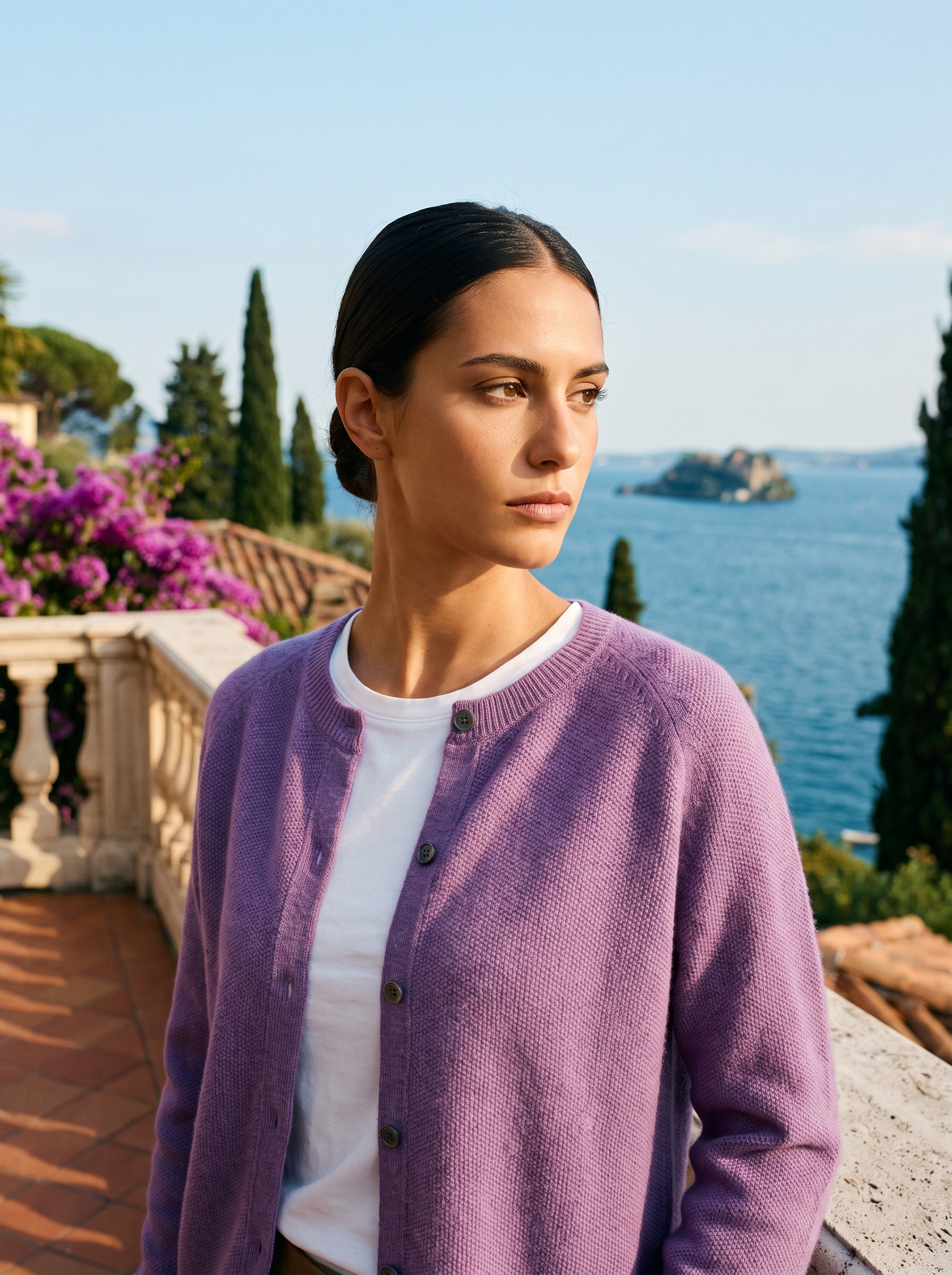 Woman wearing a purple wool-blend cardigan on a terrace overlooking Lake Como, old money style — Aveloire